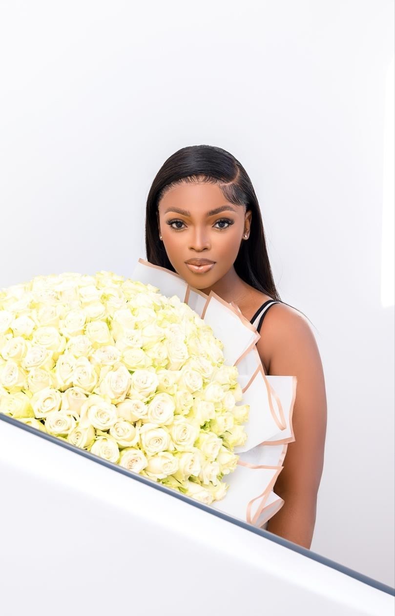 Kay Yarms holding a bouquet of white roses